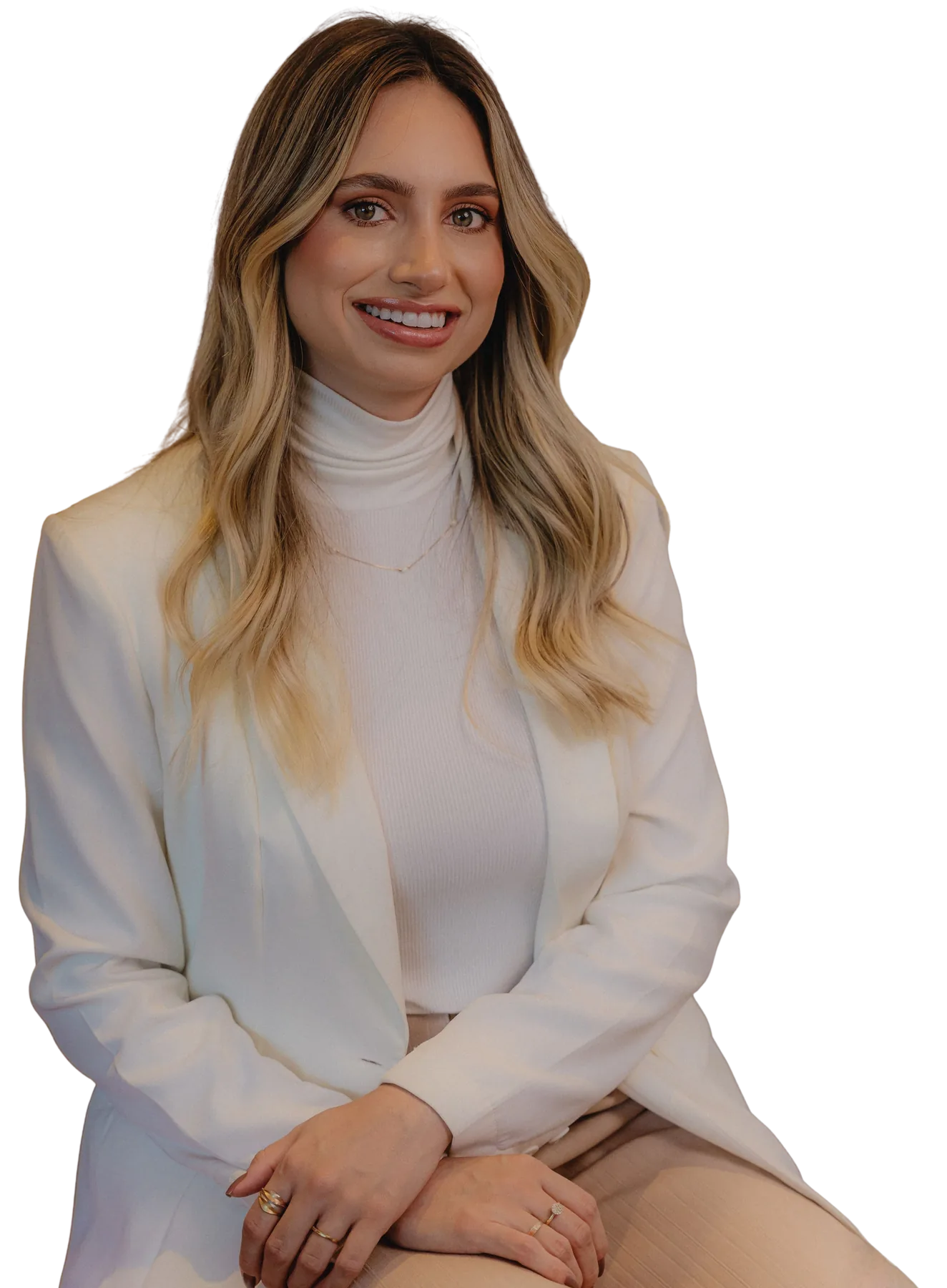 Nathália Zembrani, psicóloga, sentada em uma poltrona clara.